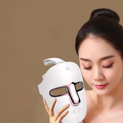 Woman using LED beauty mask to improve skin vitality and reduce wrinkles.
