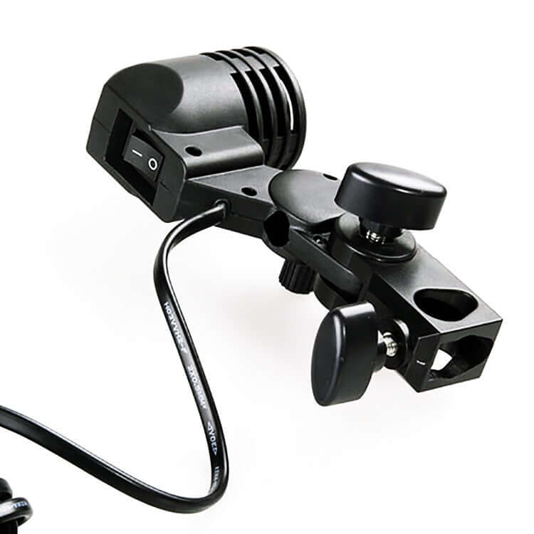 Close-up of a black photography lamp holder with manual switch and adjustable clamp for lighting accessories.