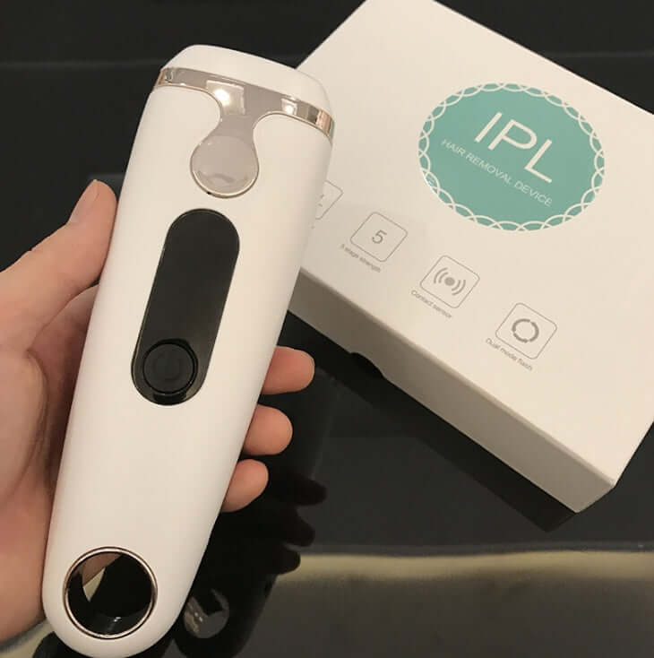 Laser hair removal device with IPL technology, featuring adjustable settings, presented with packaging.