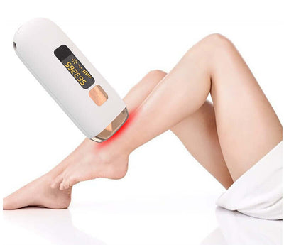 Laser hair removal device in use on a woman's leg, showcasing its advanced infrared technology and LCD display.
