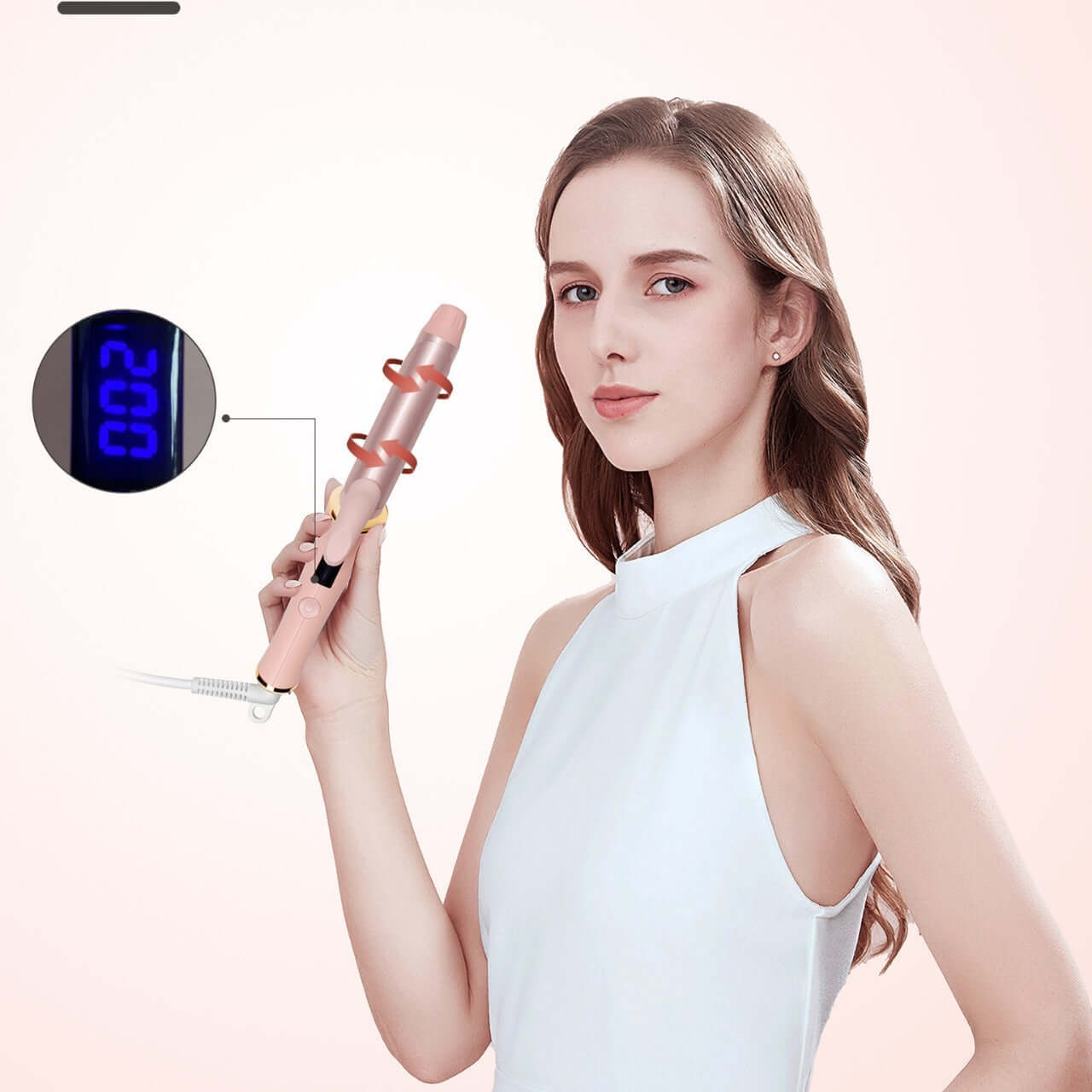 Woman using a portable automatic hair curler with a digital display for temperature settings.