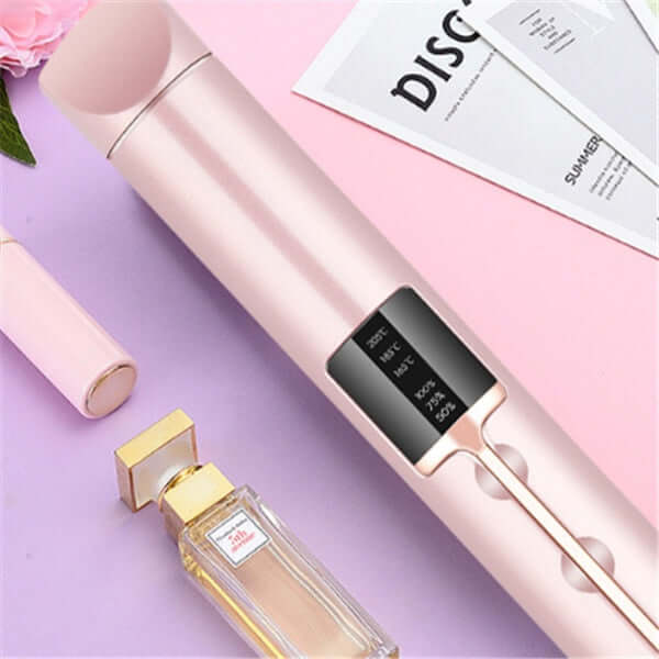 Wireless splint hair straightener in rose gold with digital temperature display and surrounding beauty products.