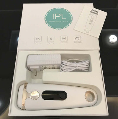 Laser hair removal device with IPL technology, accessories, and user manual in a sleek packaging.