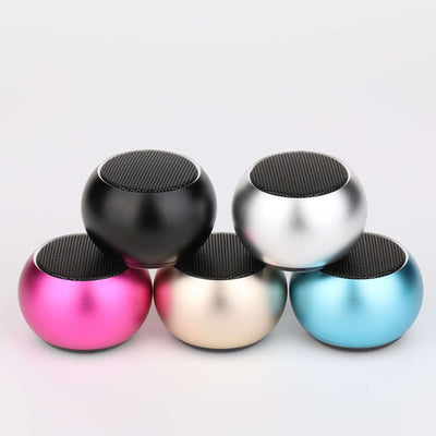 Colorful outdoor portable mini Bluetooth speakers in black, pink, silver, gold, and blue.