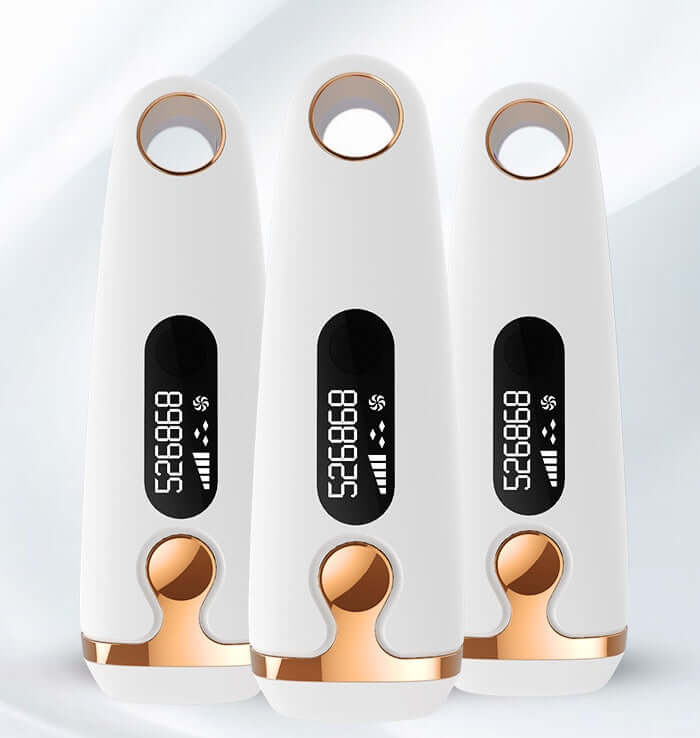 Three laser hair removal devices with LCD displays, designed for home use, featuring adjustable gears and a sleek white and gold design.