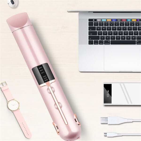 Wireless splint hair straightener in pink next to a laptop and charging cables, showcasing sleek design and adjustable temperature.