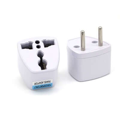 Travel adapter for multiple plug types, white, compact design for international use.
