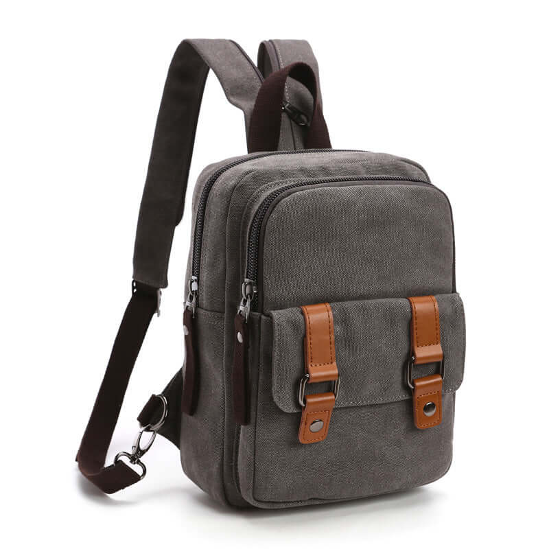 Square vertical outdoor travel backpack in gray with PU lining and casual design, featuring dual front pockets and zipper closure.