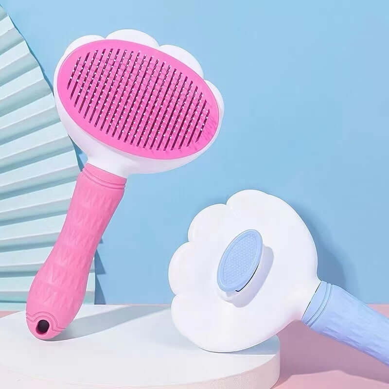 Pet hair removal gadget featuring flower needle combs in pink and blue, ideal for grooming cats and dogs.