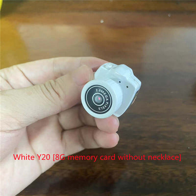 Mini camera in hand, White Y20 model with 8G memory card, suitable for photography and video recording.