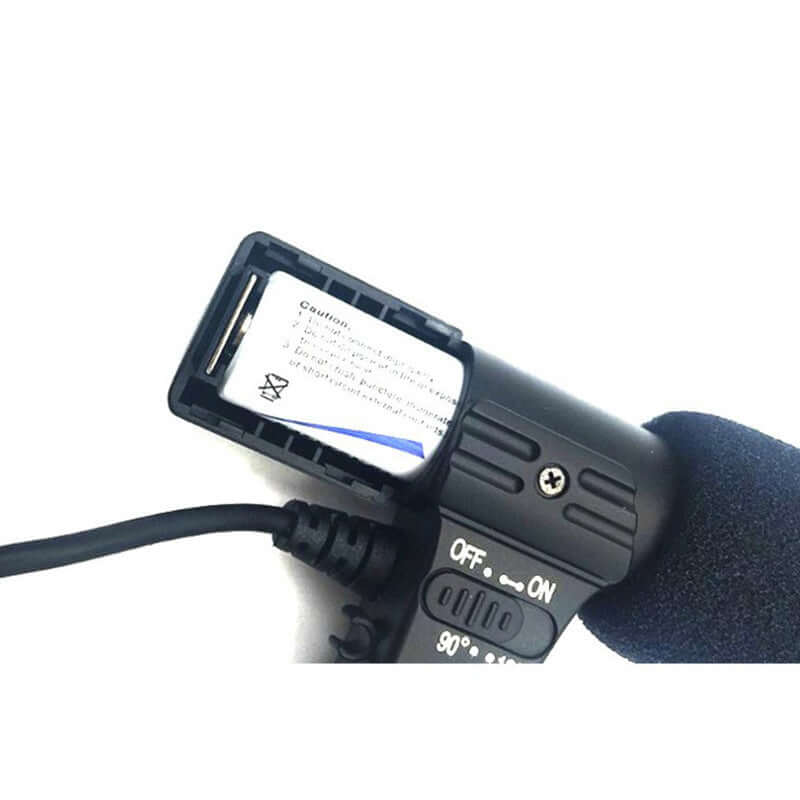 Close-up view of a camera microphone with a battery compartment and on-off switch.