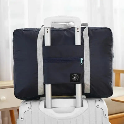 Travel handbag on a suitcase with a secure front pocket, designed for convenience and style in travel.