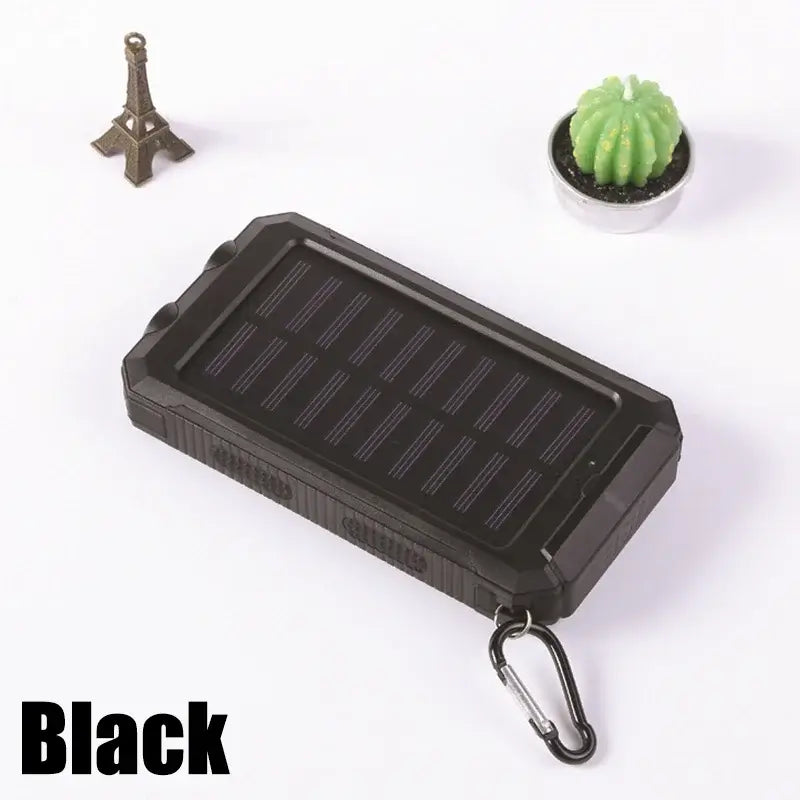 Black portable solar power bank with LED light, waterproof design, and carabiner clip, ideal for outdoor use.