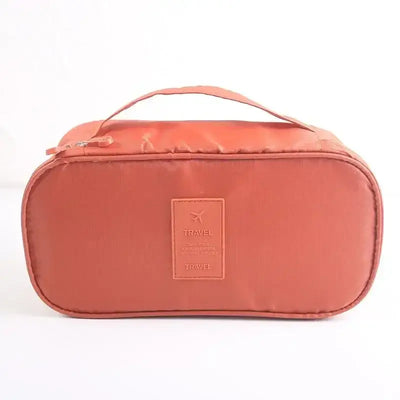 Lightweight travel underwear organizer bag in terracotta color, perfect for packing cubes for women on the go.