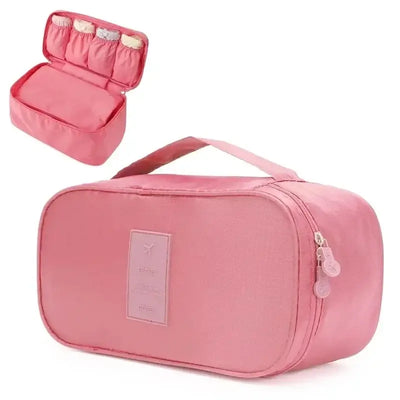 Pink travel underwear organizer bag with handle and compartments for easy packing and organization.