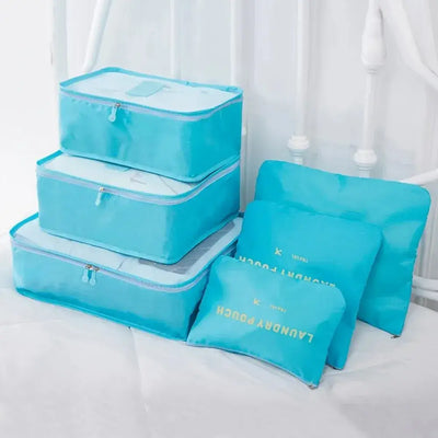 Set of 6 blue travel packing cubes and pouches for organized luggage storage and ease of travel.