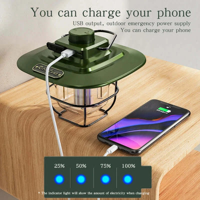 Rechargeable LED camping lantern charging a smartphone via USB on a wooden table.