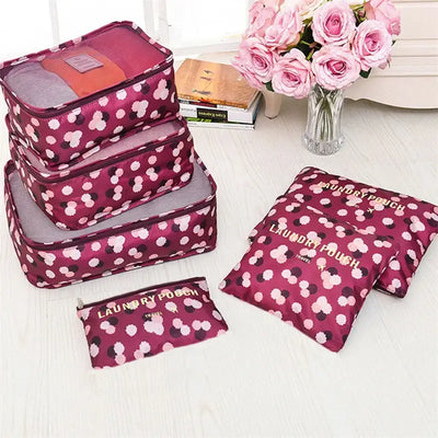 6pcs travel packing cubes and laundry pouch in pink floral pattern for suitcase organization.