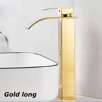 Gold long waterfall sink faucet beside white washbasin for contemporary bathroom design.