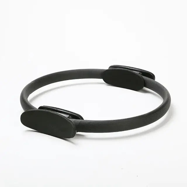 Black Pilates ring for body shaping and fitness exercises, ideal for beginners, durable and practical equipment.