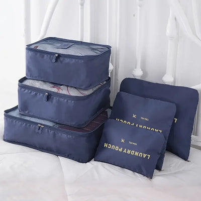 Set of navy blue travel packing cubes for organized luggage and easy access to clothes and accessories.