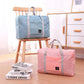 Nevytech Women’s Travel Handbag Waterproof in blue and pink colors displayed on a wooden chair.