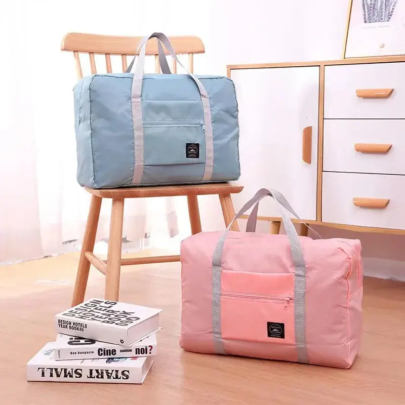Travel handbags in blue and pink, featuring sturdy handles and compact design, perfect for storage and travel.
