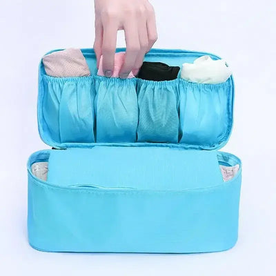 Lightweight travel underwear organizer bag in blue with compartments for bras and socks, ideal for women.