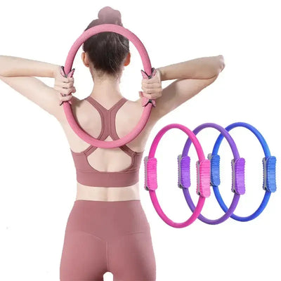 Woman using a pink Pilates ring for fitness exercise, showcasing multiple colored fitness rings in the background.