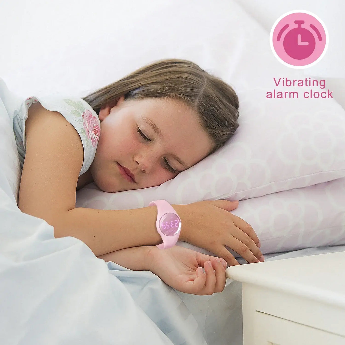 Child sleeping with pink digital fitness tracker watch featuring a vibrating alarm clock.