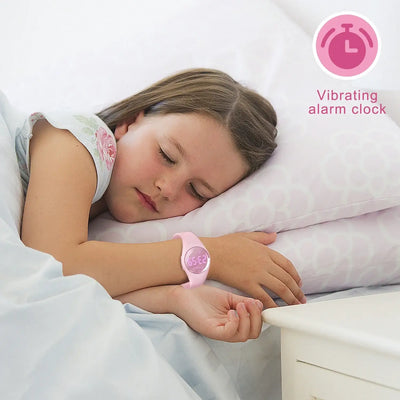 Child sleeping with pink digital fitness tracker watch featuring a vibrating alarm clock.