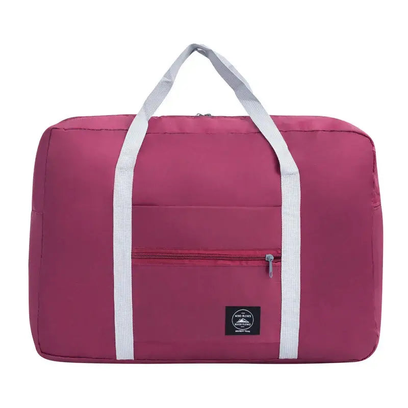 Large capacity pink travel handbag with white straps and front pocket for convenient storage.