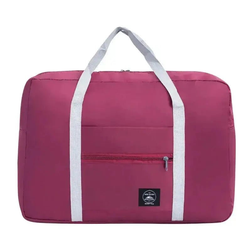 Nevytech Women’s Travel Handbag Waterproof in blue and pink colors displayed on a wooden chair.