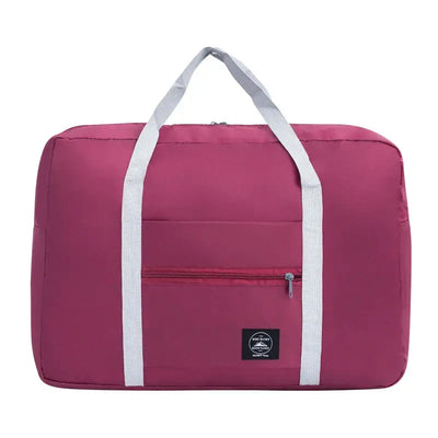 Large capacity pink travel handbag with white straps and front pocket for convenient storage.