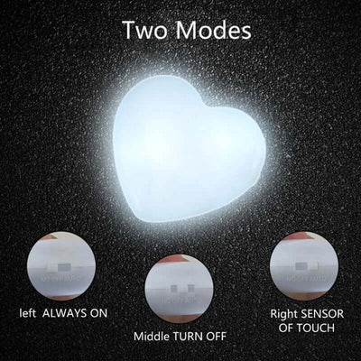 Heart-shaped LED light showing two modes: always on and sensor of touch, ideal for purse decoration.