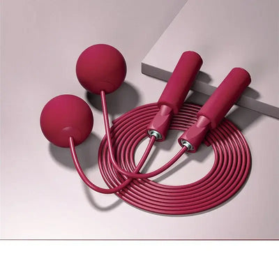 Cordless skipping rope with heavy balls, designed for fitness training and aerobics, featuring pink PU rope and ergonomic handles.