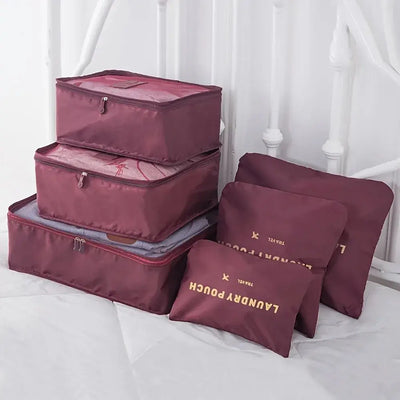 Set of 6 maroon travel luggage packing cubes and pouches, ideal for organizing clothes and accessories.