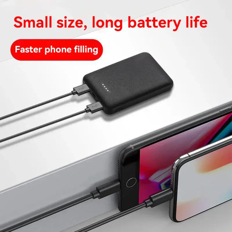 Compact black power bank charging two phones with text highlighting long battery life and fast charging features.