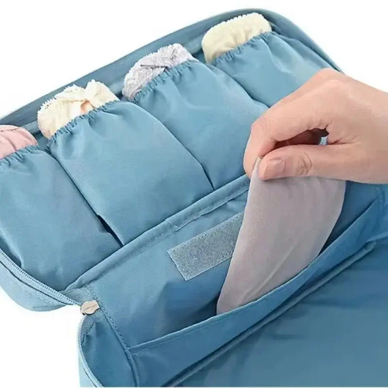 Lightweight travel underwear organizer bag with multiple compartments for packing bras and lingerie.