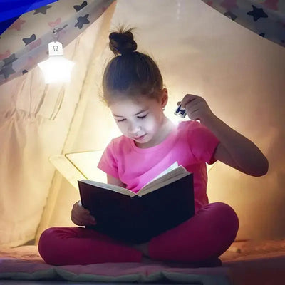 Child reading a book in a cozy tent environment, illuminated by a hanging star-shaped lamp.