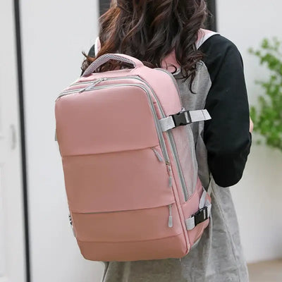 Stylish pink travel backpack for women, featuring ergonomic design and multiple compartments for convenience.