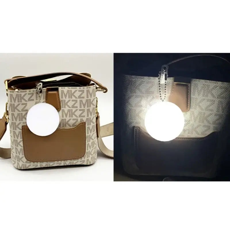 Heart-shaped LED light purse charm illuminating a handbag, showcasing its automatic motion activation feature.