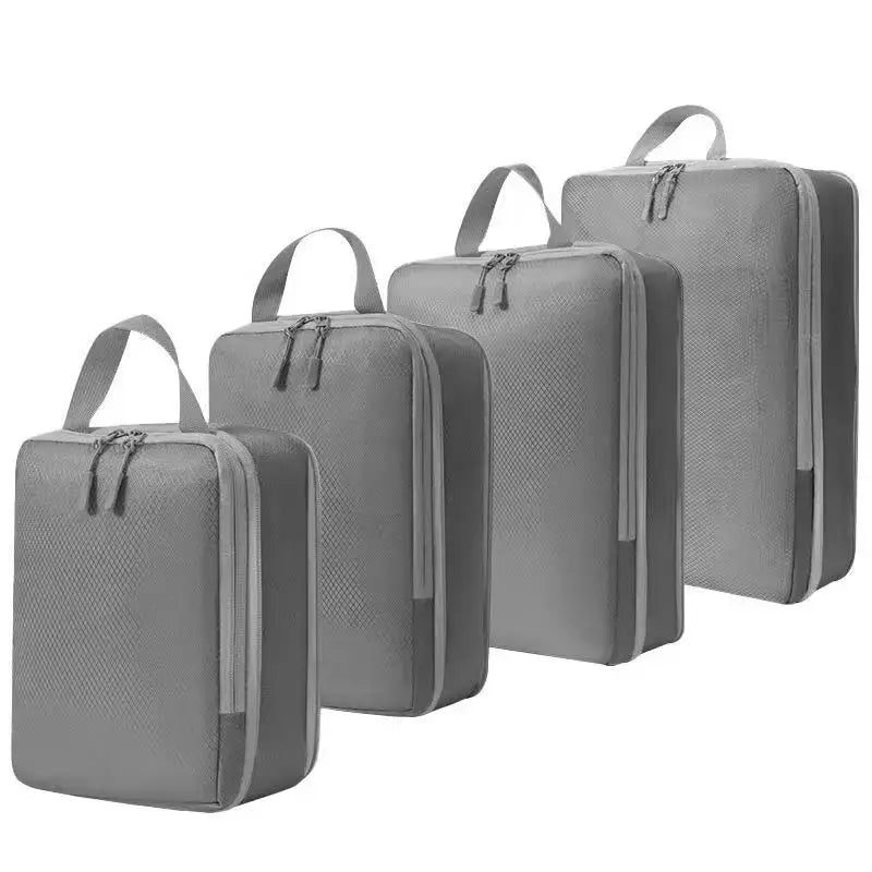 4 grey compression packing cubes set for travel organization and efficient packing.