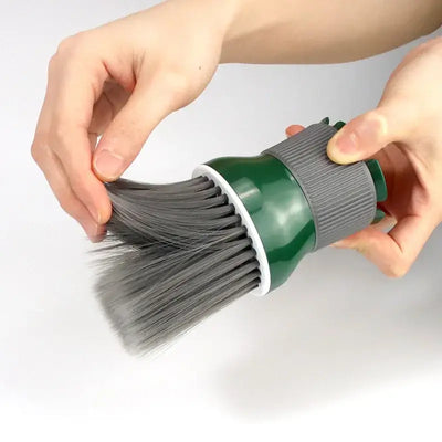 Person holding a green Barbertop hair dryer brush with soft bristles for salon haircut cleaning.