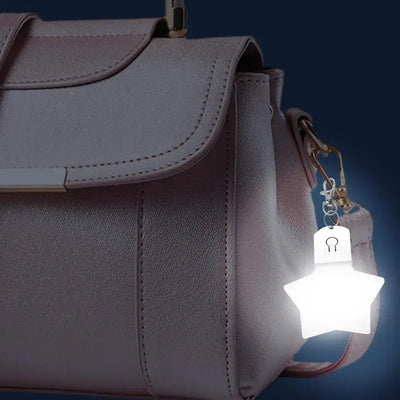 Purse heart LED light attached to a stylish pink handbag, illuminating softly for added charm.