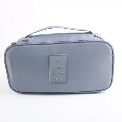 Lightweight gray travel underwear organizer bag with handle and travel logo, ideal for packing cubes for women.