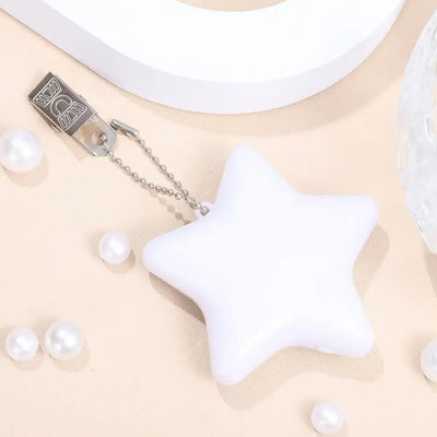 White star-shaped LED handbag light with keychain clip, perfect for purses and outdoor use.