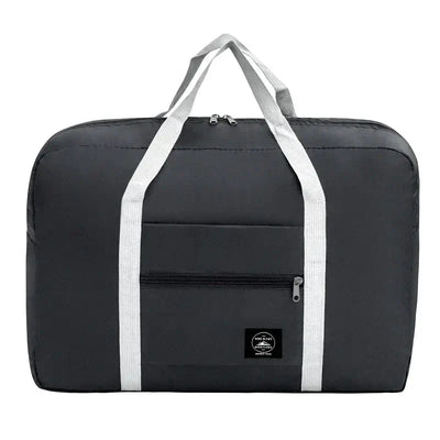 Black travel handbag with reinforced handles and front zipper pocket, ideal for storage and travel convenience.