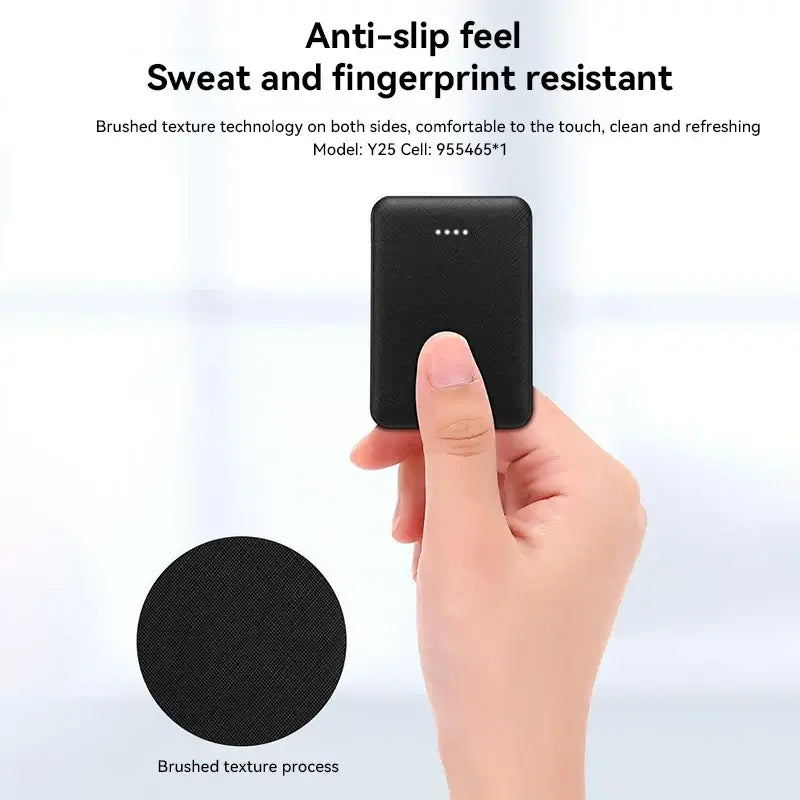 Portable USB charger with anti-slip texture, sweat and fingerprint resistant, held in a hand.