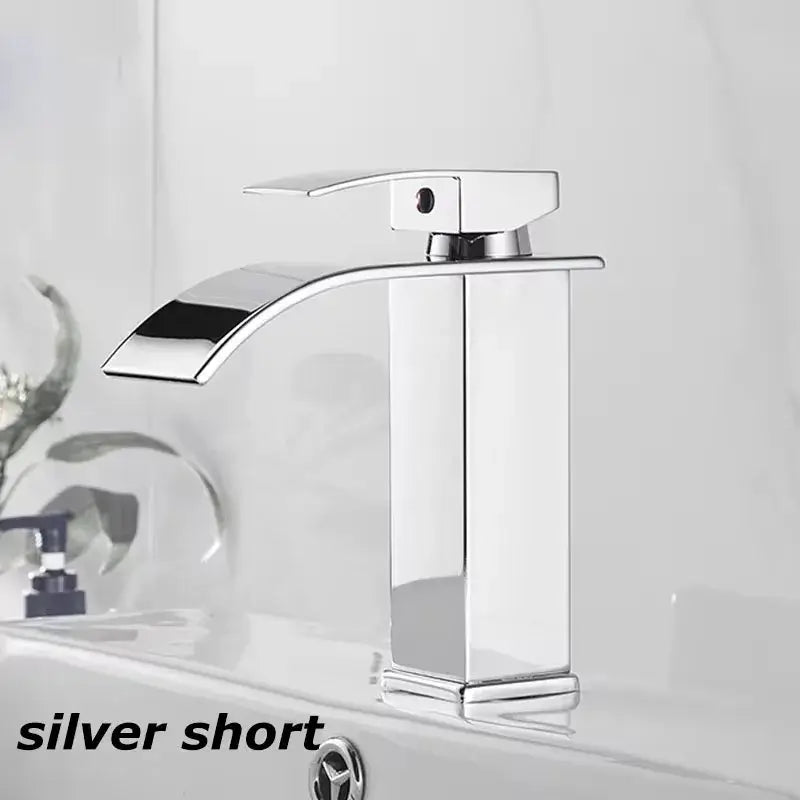Contemporary silver short sink faucet with sleek design for bathroom basin, deck-mounted hot and cold mixer.